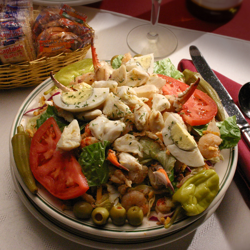 image of a house salad with jumbo lump crab meat and crab legs